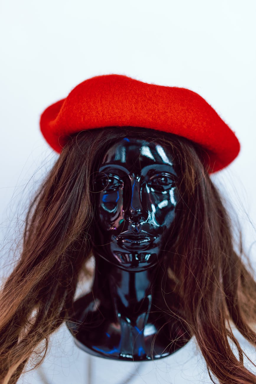 woman in red hat with black skull face paint