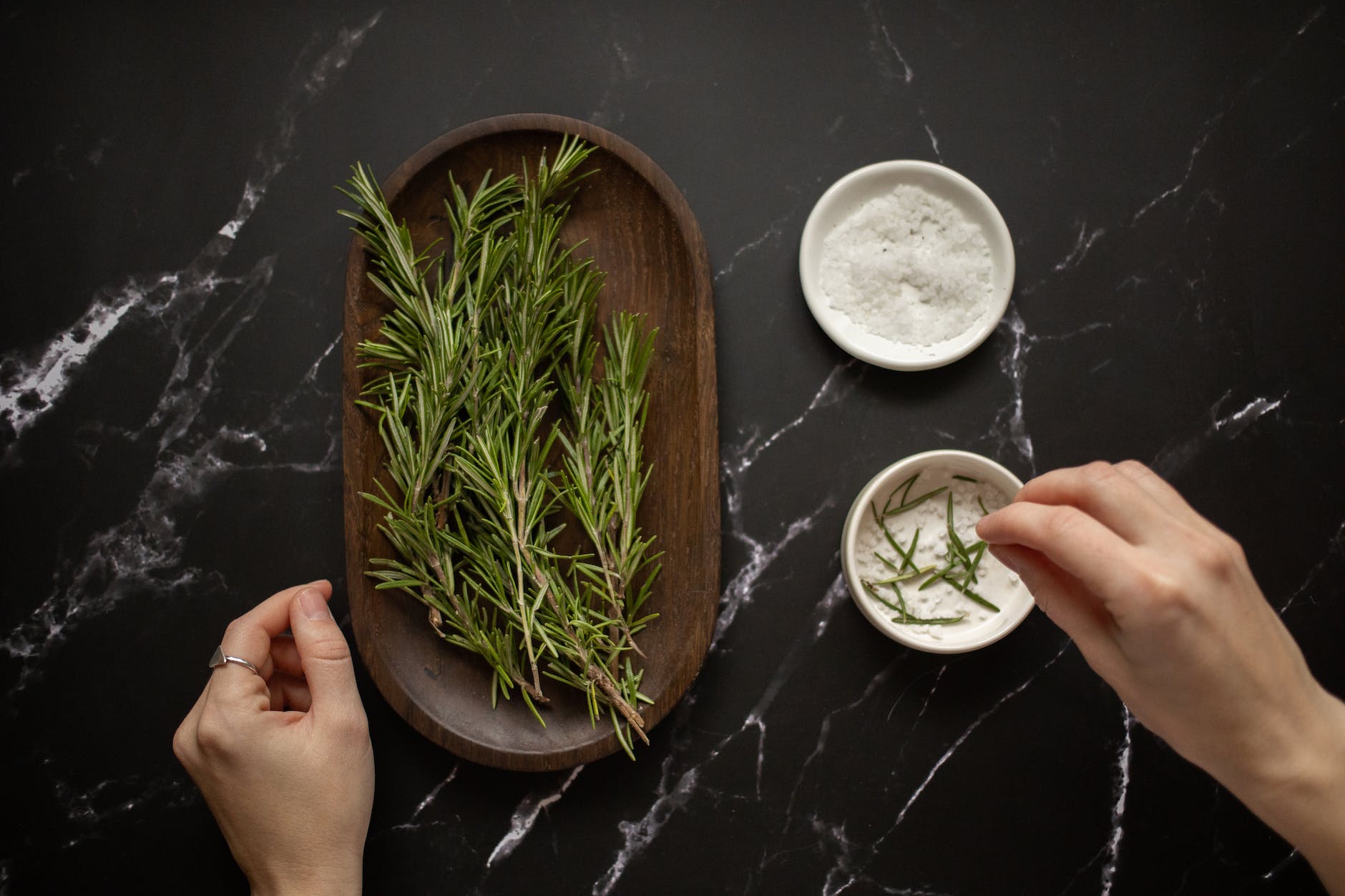 female preparing natural scrub with rosemary and salt