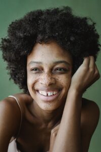 portrait of smiling woman on green background