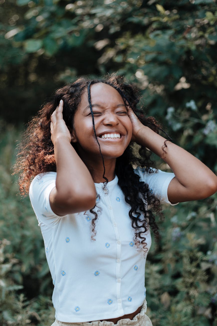 teenage girl holding hands on head and laughing