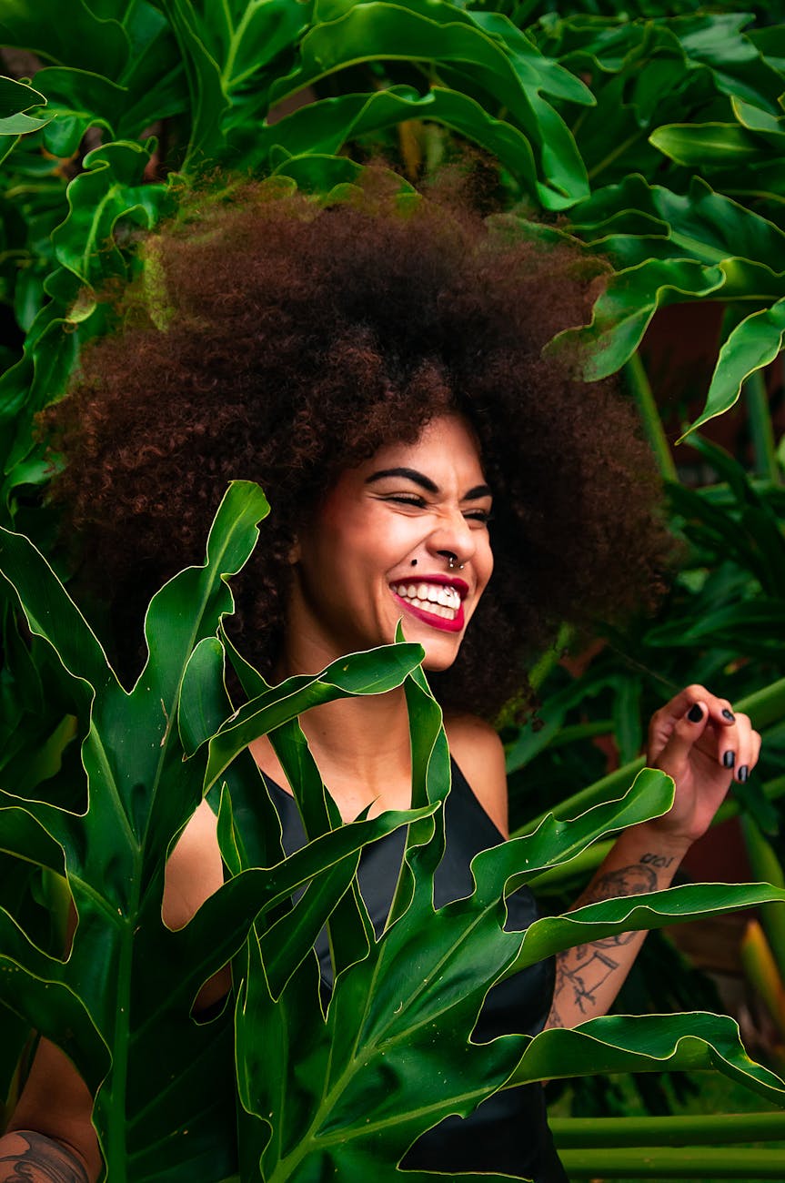 woman surrounded by green leafed plants